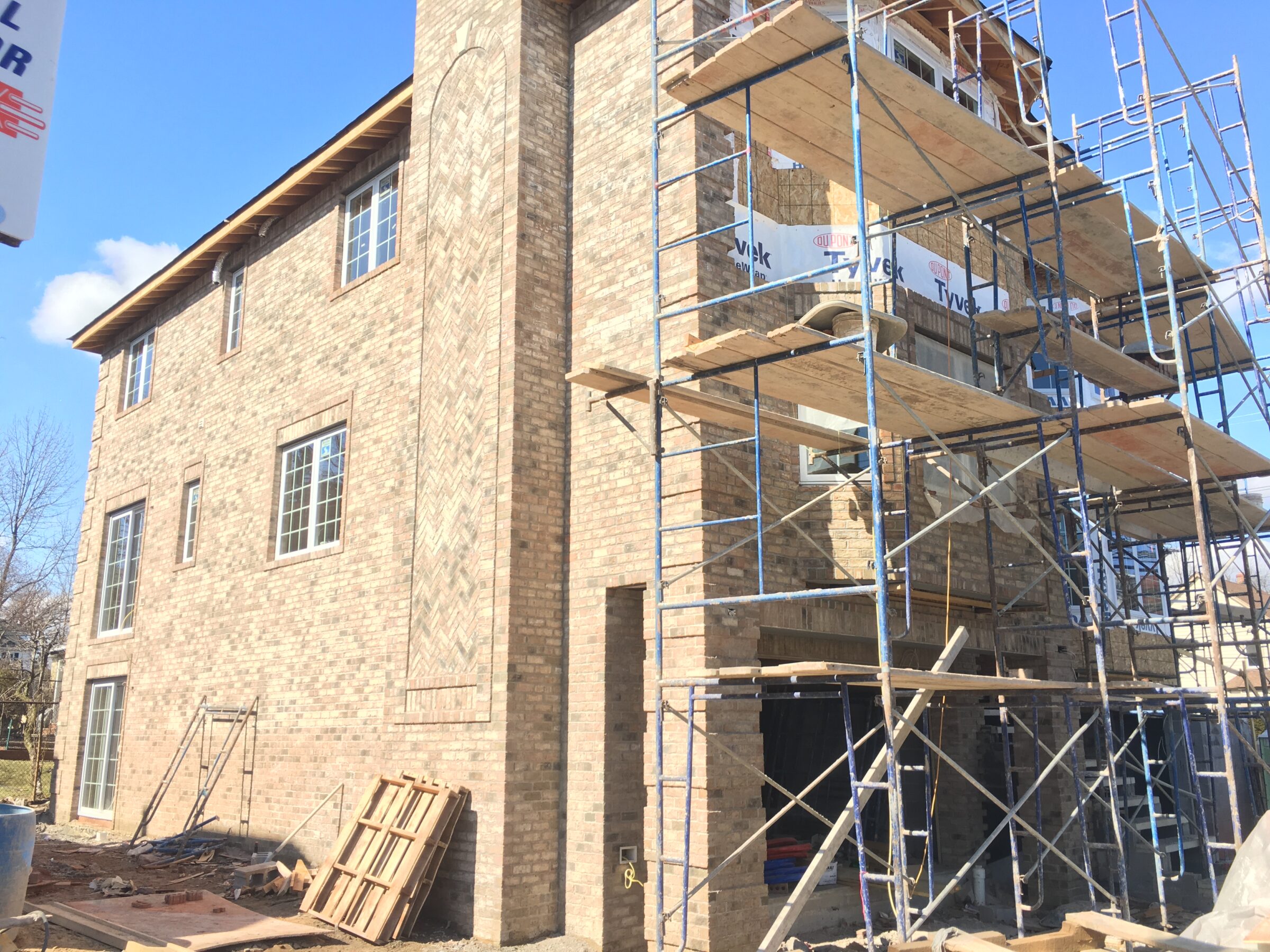 exterior of house getting new bricks during a fix and flip